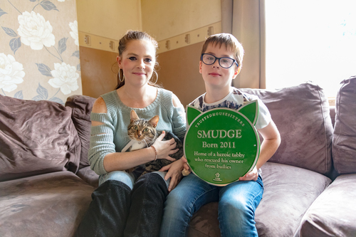 Smudge the cats owner and plaque