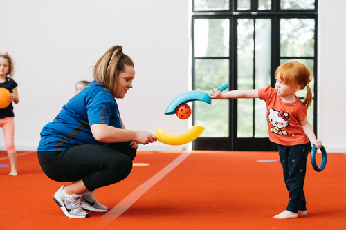 Coach Core apprentice playing with child