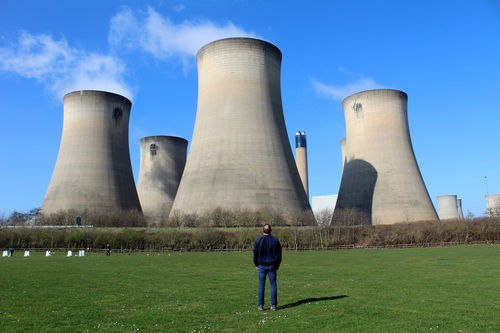 Man stood in front of a power plant