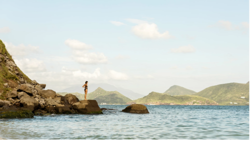 Woman on rock overlooking Nevis 