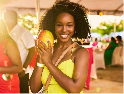 Lady at Mango Festival with a mango
