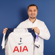 Elithair Dr Balwi holds Tottenham shirt